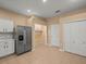 Well-organized kitchen with stainless steel fridge and access to additional room at 13049 Moonstone Way, Spring Hill, FL 34609