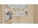 Eat-in kitchen featuring stainless steel appliances, white cabinets, and a breakfast bar at 13049 Moonstone Way, Spring Hill, FL 34609