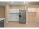 Bright kitchen with stainless steel refrigerator and access to an additional room at 13049 Moonstone Way, Spring Hill, FL 34609