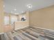 Open-concept living area with wood-look flooring and neutral walls at 13049 Moonstone Way, Spring Hill, FL 34609