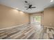 Bright living room features sliding glass doors and wood-look floors at 13049 Moonstone Way, Spring Hill, FL 34609