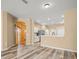 Spacious living area with wood-look flooring, open to the kitchen with stainless steel appliances at 13049 Moonstone Way, Spring Hill, FL 34609