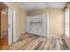 Pantry with white cabinets, wood-look tile flooring, and subway tile backsplash at 13049 Moonstone Way, Spring Hill, FL 34609