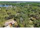 Expansive aerial view of the community showcasing lush greenery, homes, and access to a serene lake at 13901 Vacation Ln, Odessa, FL 33556