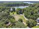 An aerial view showing neighborhood streets and nearby lake at 13901 Vacation Ln, Odessa, FL 33556