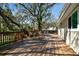Expansive outdoor deck with wood flooring and a view of the backyard's mature trees at 13901 Vacation Ln, Odessa, FL 33556