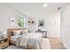 Comfortable bedroom with wood floors, neutral decor, and natural light from multiple windows at 13901 Vacation Ln, Odessa, FL 33556