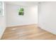 Bright bedroom featuring hardwood floors and natural light at 13901 Vacation Ln, Odessa, FL 33556