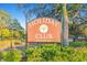 Holiday Club sign surrounded by lush greenery and landscaping at 13901 Vacation Ln, Odessa, FL 33556