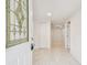 Bright foyer with white marble floors leading into the house, as seen through the decorative glass front door at 13901 Vacation Ln, Odessa, FL 33556