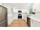 Updated kitchen with white cabinetry, stainless steel appliances, and a clean, modern design at 13901 Vacation Ln, Odessa, FL 33556