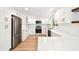 Stylish kitchen featuring white cabinets, stainless steel appliances, and quartz countertops at 13901 Vacation Ln, Odessa, FL 33556