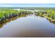 Expansive lake surrounded by lush trees and waterfront homes, offering a serene and picturesque setting at 13901 Vacation Ln, Odessa, FL 33556