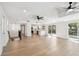 Open concept living room features hardwood floors and seamlessly blends with a contemporary kitchen, for a modern living space at 13901 Vacation Ln, Odessa, FL 33556