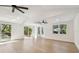 Large living room with vaulted ceilings and many windows allowing tons of natural light to stream in at 13901 Vacation Ln, Odessa, FL 33556