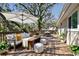 Cozy outdoor deck with comfortable seating, a dining table, and lush greenery for relaxing at 13901 Vacation Ln, Odessa, FL 33556