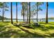 Scenic lakefront picnic area with picnic tables under the shade of beautiful, tall trees at 13901 Vacation Ln, Odessa, FL 33556