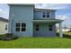 The backyard features green grass, and the blue siding matches the home's aesthetic at 14425 Maiden Ter, Lakewood Ranch, FL 34211