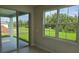 Window looking onto the outdoor patio, with large sliding glass doors and green grass at 14425 Maiden Ter, Lakewood Ranch, FL 34211