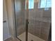 Modern tiled shower featuring a glass door, built-in bench, and sleek fixtures at 14425 Maiden Ter, Lakewood Ranch, FL 34211