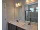 Bathroom features dual sinks, quartz countertops, modern fixtures, and a walk-in shower at 14429 Maiden Ter, Lakewood Ranch, FL 34211