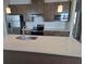 Modern kitchen featuring stainless steel appliances and a spacious island with quartz countertop at 14429 Maiden Ter, Lakewood Ranch, FL 34211