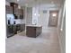 Open-concept kitchen with stainless appliances, kitchen island, and modern fixtures at 14429 Maiden Ter, Lakewood Ranch, FL 34211
