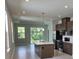 Stylish kitchen with an island, stainless steel appliances, and seamless flow to the dining area at 14429 Maiden Ter, Lakewood Ranch, FL 34211