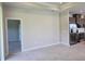 Open living area with tile flooring adjacent to modern kitchen with stainless appliances at 14429 Maiden Ter, Lakewood Ranch, FL 34211