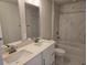 Contemporary bathroom featuring double sinks, sleek countertops, and modern fixtures at 14437 Maiden Ter, Lakewood Ranch, FL 34211