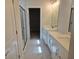 Bathroom showcasing double vanities, modern fixtures, walk-in shower, and neutral color palette at 14437 Maiden Ter, Lakewood Ranch, FL 34211