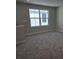 Upstairs bedroom with large window and neutral color palette at 14437 Maiden Ter, Lakewood Ranch, FL 34211