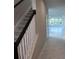 Hallway and stairway leading to living room with marble floors and white railing at 14437 Maiden Ter, Lakewood Ranch, FL 34211