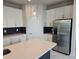 Modern kitchen with quartz countertops, a stainless steel refrigerator, and ample storage at 14437 Maiden Ter, Lakewood Ranch, FL 34211