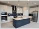 Modern kitchen featuring stainless steel appliances, a stylish island, and sleek countertops at 14437 Maiden Ter, Lakewood Ranch, FL 34211