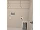 Bright laundry area with a utility sink and built-in wire shelving for storage convenience at 14437 Maiden Ter, Lakewood Ranch, FL 34211