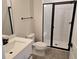 Bathroom with modern black fixtures, a glass shower door, and a white single sink vanity at 14441 Maiden Ter, Lakewood Ranch, FL 34211