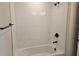 Bathroom featuring a tub with white subway tile surround and matte black fixtures at 14441 Maiden Ter, Lakewood Ranch, FL 34211