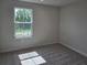 Cozy bedroom with plush carpeting and natural light streaming through the window at 14441 Maiden Ter, Lakewood Ranch, FL 34211