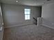 Bright bonus room filled with neutral carpet, base molding, and natural light from a window at 14441 Maiden Ter, Lakewood Ranch, FL 34211
