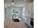 Bright kitchen with a large island, quartz countertops, and modern lighting at 14441 Maiden Ter, Lakewood Ranch, FL 34211