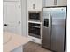 Modern kitchen featuring stainless steel appliances and a white quartz countertop island at 14441 Maiden Ter, Lakewood Ranch, FL 34211