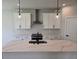 Well-lit kitchen featuring white cabinets, stainless steel appliances, and a large kitchen island at 14441 Maiden Ter, Lakewood Ranch, FL 34211