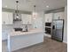 Modern kitchen with white cabinets, stainless steel appliances, and a large center island at 14441 Maiden Ter, Lakewood Ranch, FL 34211