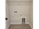 Functional laundry room with tiled floor, washer hookups, and upper shelf storage at 14441 Maiden Ter, Lakewood Ranch, FL 34211