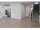 Open concept living area features tile flooring, stainless appliances, and stairs to the second level at 14441 Maiden Ter, Lakewood Ranch, FL 34211
