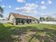 Expansive backyard with lush green lawn, manicured hedges, and a white vinyl fence at 14646 Coronado Dr, Spring Hill, FL 34609
