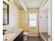 Bathroom with black framed mirror, neutral countertop, toilet, and tub shower combo at 14646 Coronado Dr, Spring Hill, FL 34609