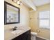 Bathroom with black framed mirror, neutral countertop, toilet, and tub shower combo at 14646 Coronado Dr, Spring Hill, FL 34609