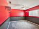 Red bedroom with gray carpet, a ceiling fan, and a window at 14646 Coronado Dr, Spring Hill, FL 34609